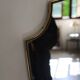 Brass mirror with crest, bead frieze, Italian design style.