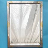 Faceted modernist wall mirror in steel and brass, geometric mixed metal frame 1970s.