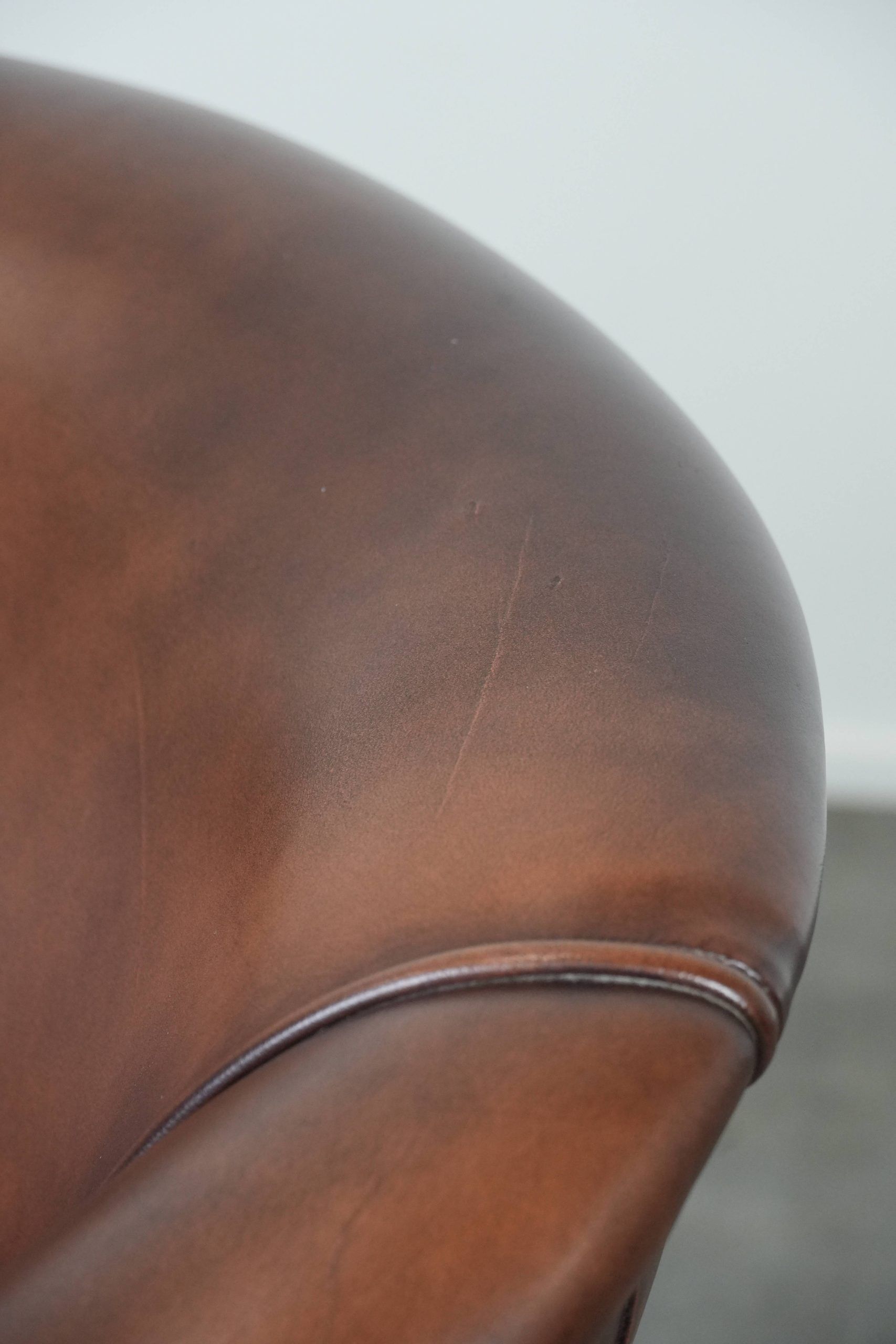 Great luxurious brown cowhide club armchair with matching piping