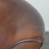 Great luxurious brown cowhide club armchair with matching piping