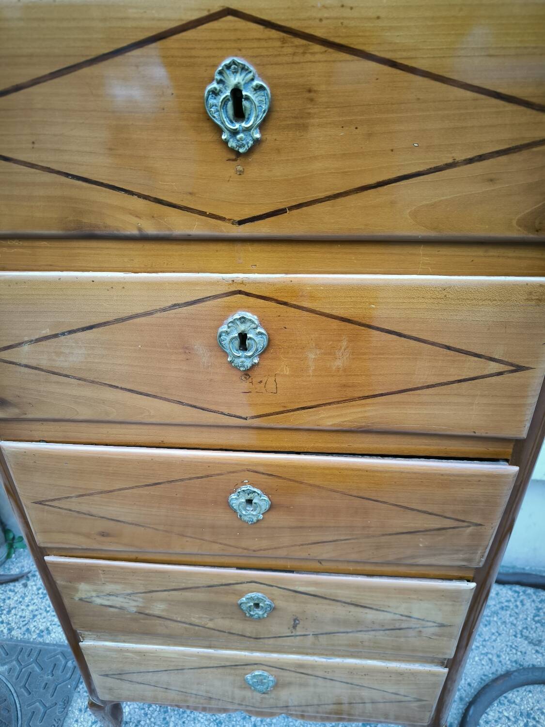 A seven-day chest of drawers in solid cherry wood with ebony stringing, 18th century