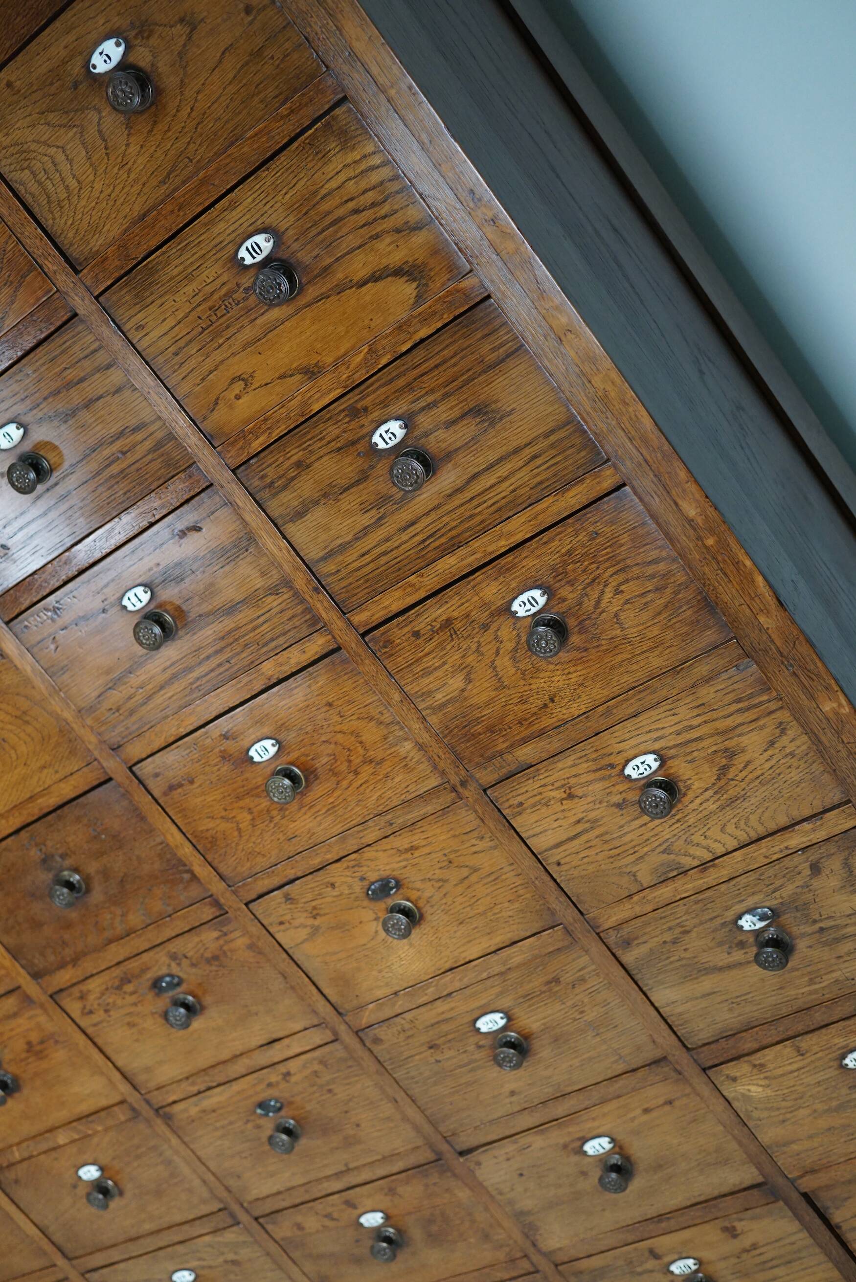 Large dutch oak apothecary cabinet / barber cabinet with enamel shields, 1900s