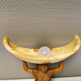 Wall lamp, where the base is a carved wooden lady holding the shade which is made of alabaster 1920s
