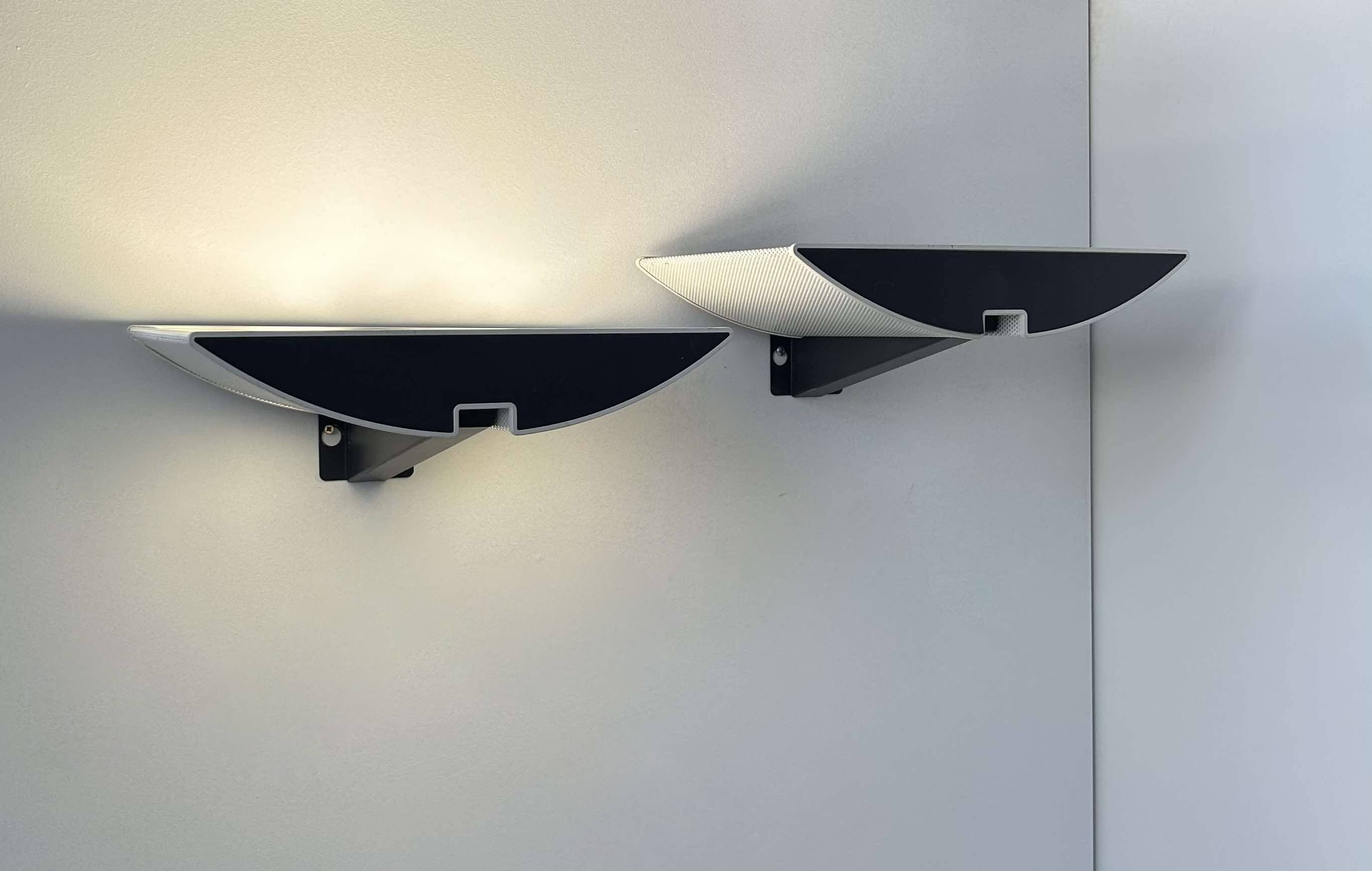 Pair of modernist wall lights, black and white lacquered metal, Italy 1980