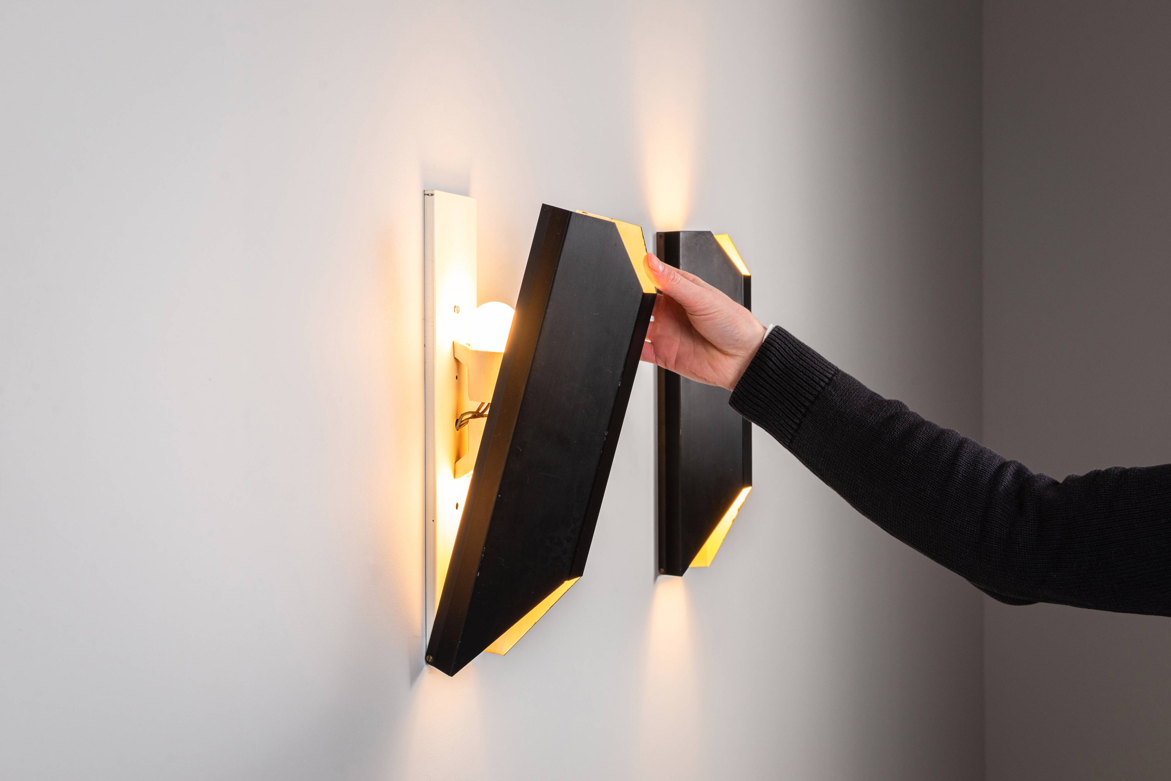 Architectural pair of vintage black metal wall lamps with angular geometric