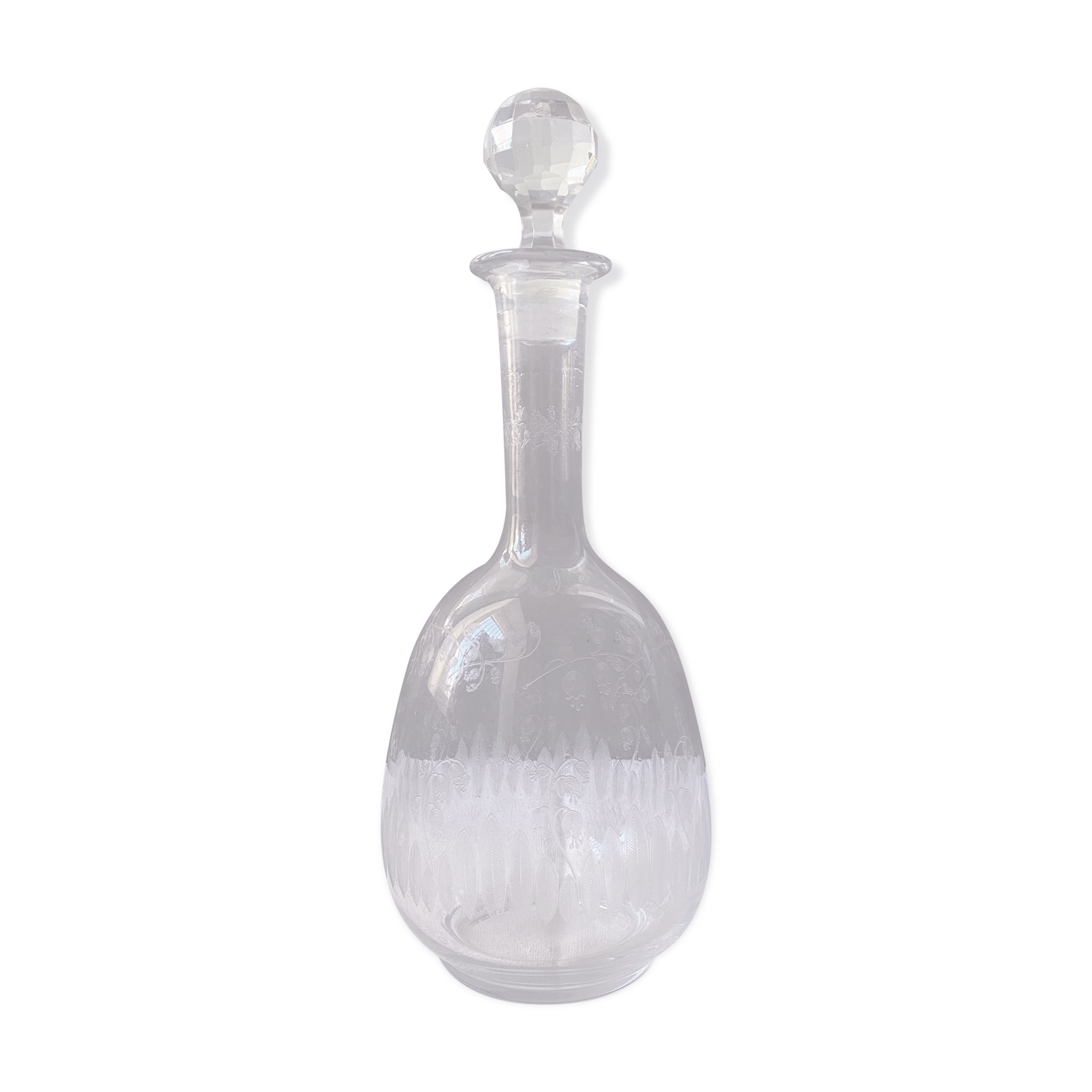 Carved glass decanter with floral decorations