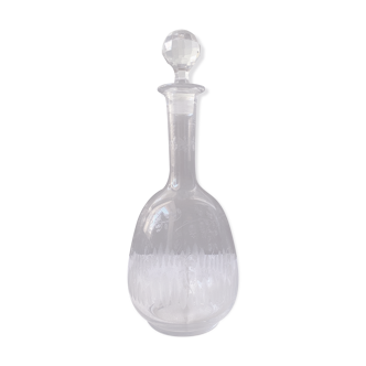 Carved glass decanter with floral decorations