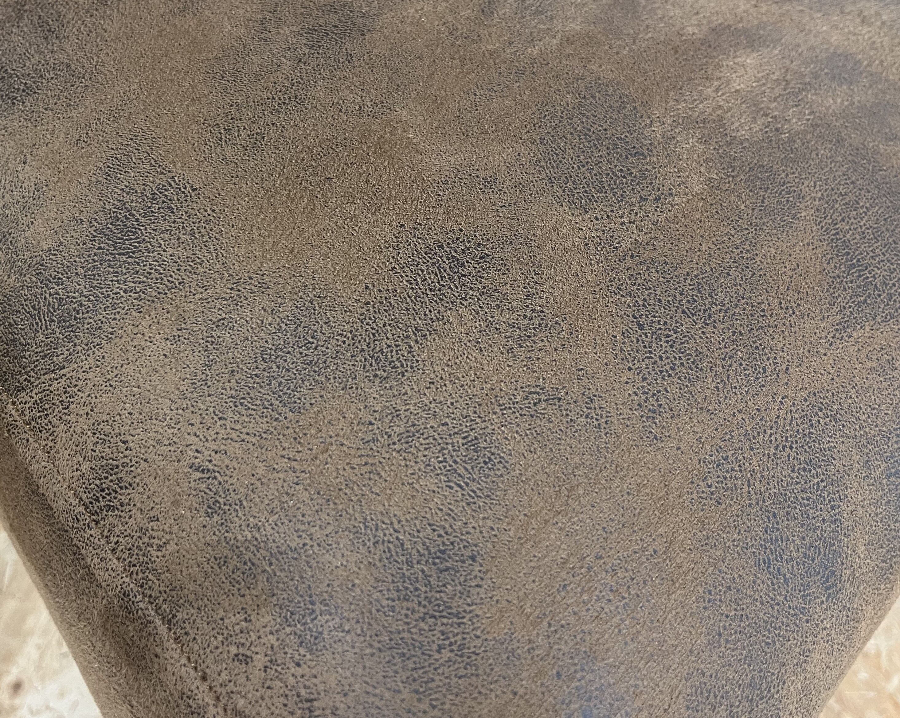 Upholstered armchair in brown imitation leather
