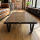 Industrial coffee table: mining cart, weathered wood top, quarries.