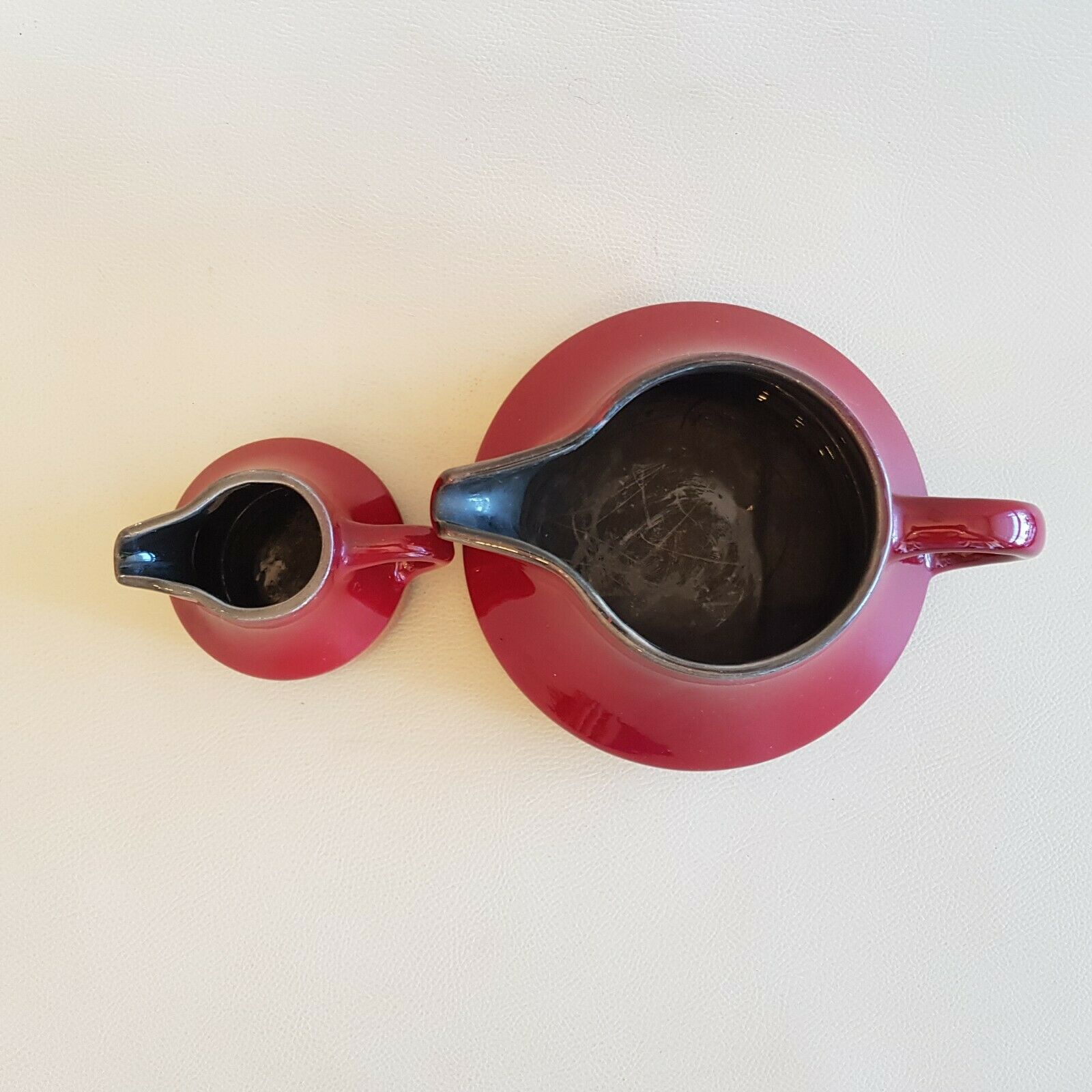 Teapot and milk jar in burgundy red ceramic