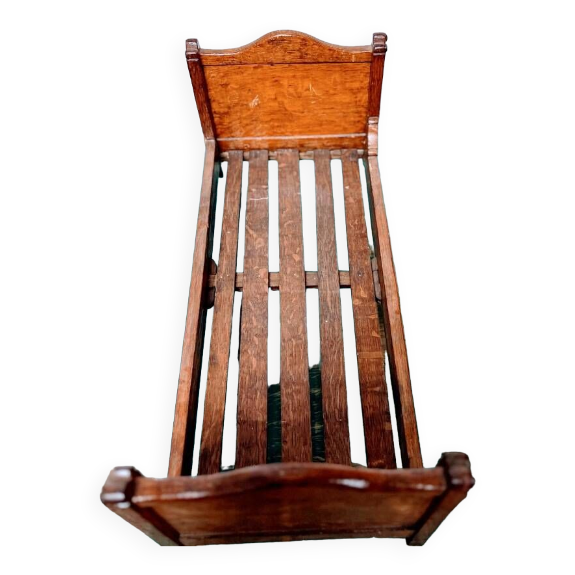 Old doll's bed in varnished wood