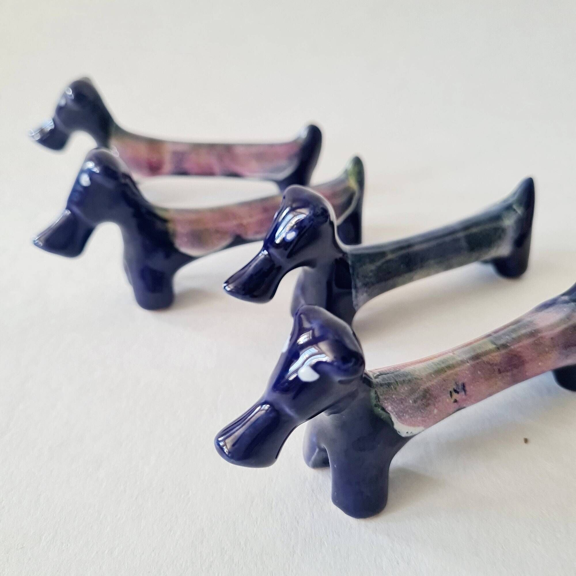 Set of 8 vintage ceramic knife rests, retro dog design.