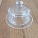 2 transparent glass butter dishes accompanied by their matching cloches.