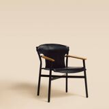 Maërl armchair, Galathée model, black leather, solid wood armrests of your choice