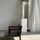 Small low armchair in varnished brown wood