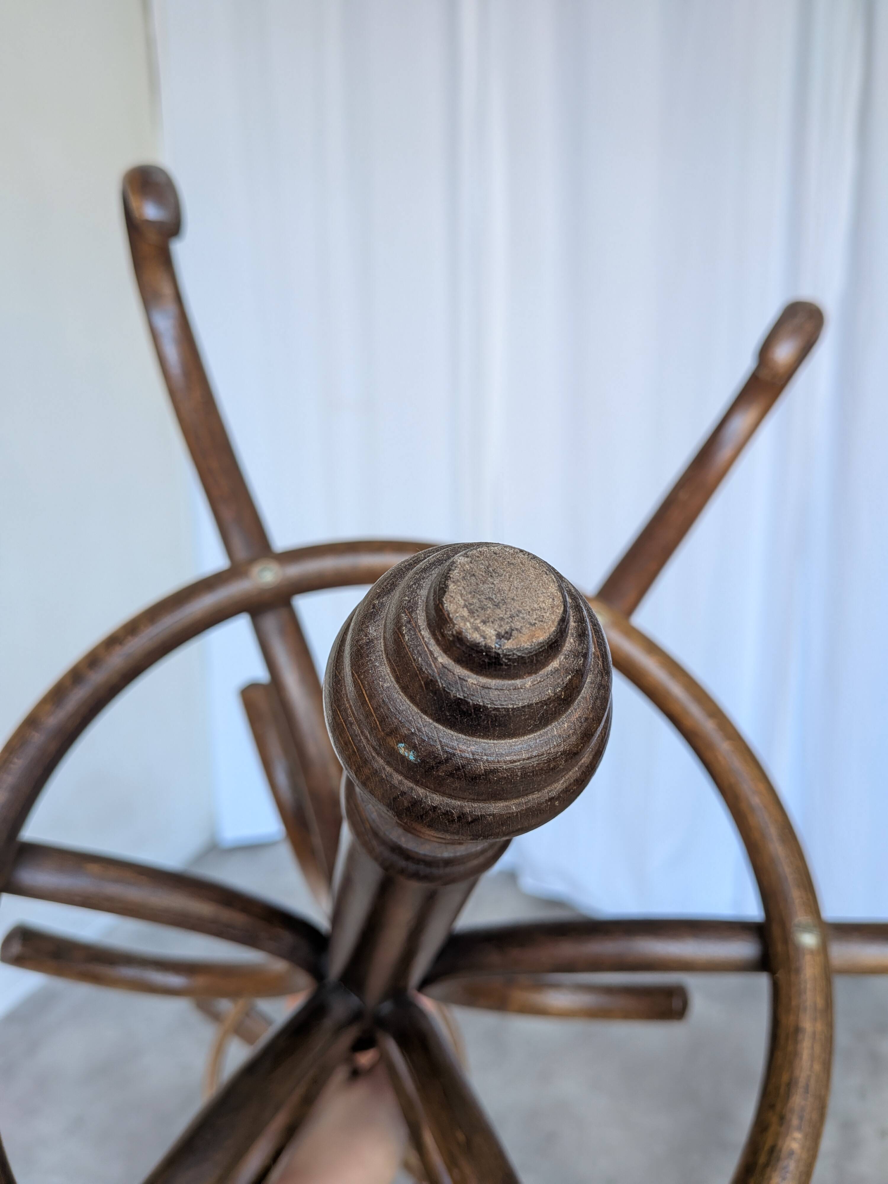 Vintage bentwood coat rack in Thonet style / Dark wood coat rack with shadow.