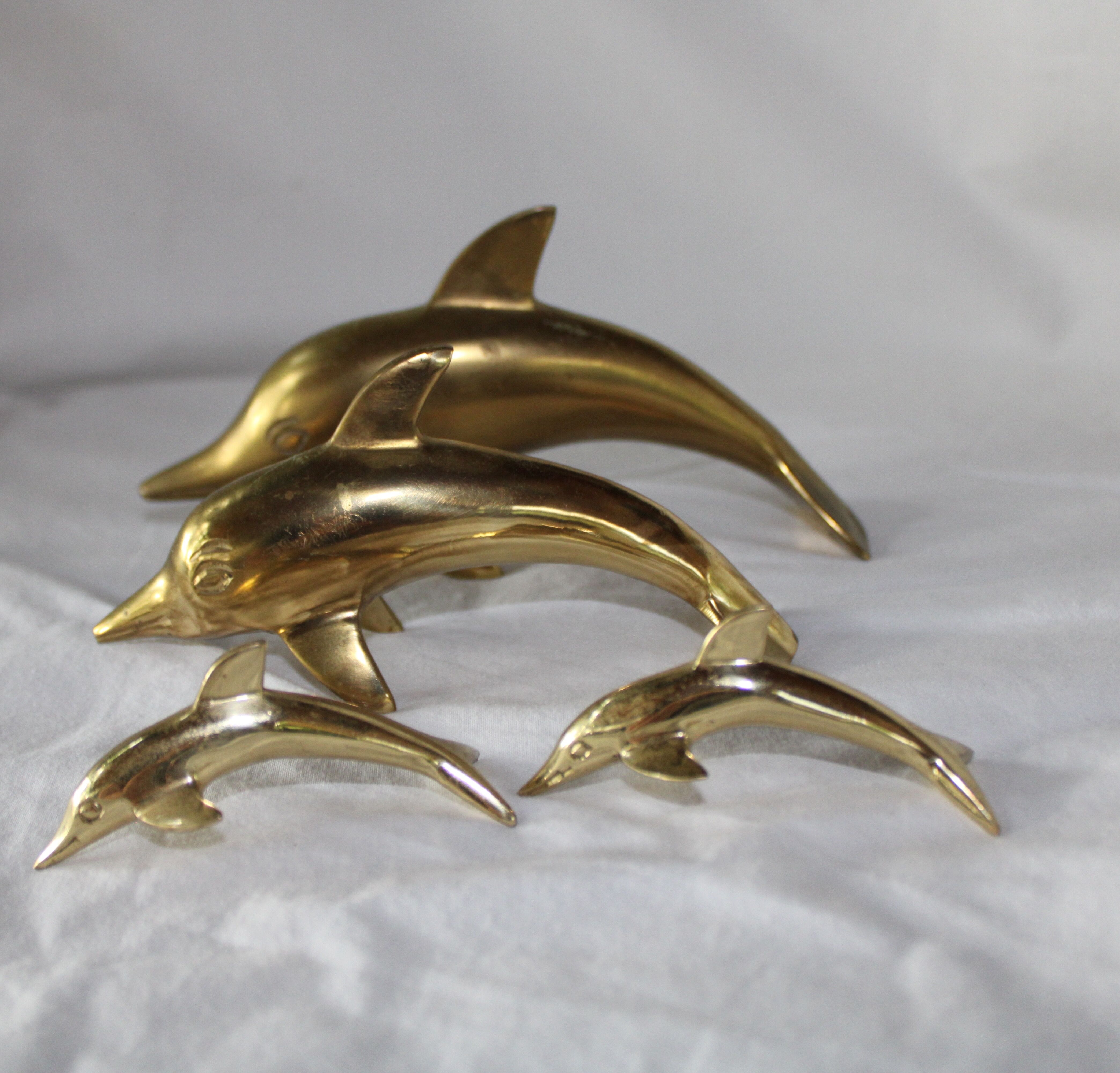 Family of dolphins in vintage brass