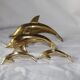 Family of dolphins in vintage brass
