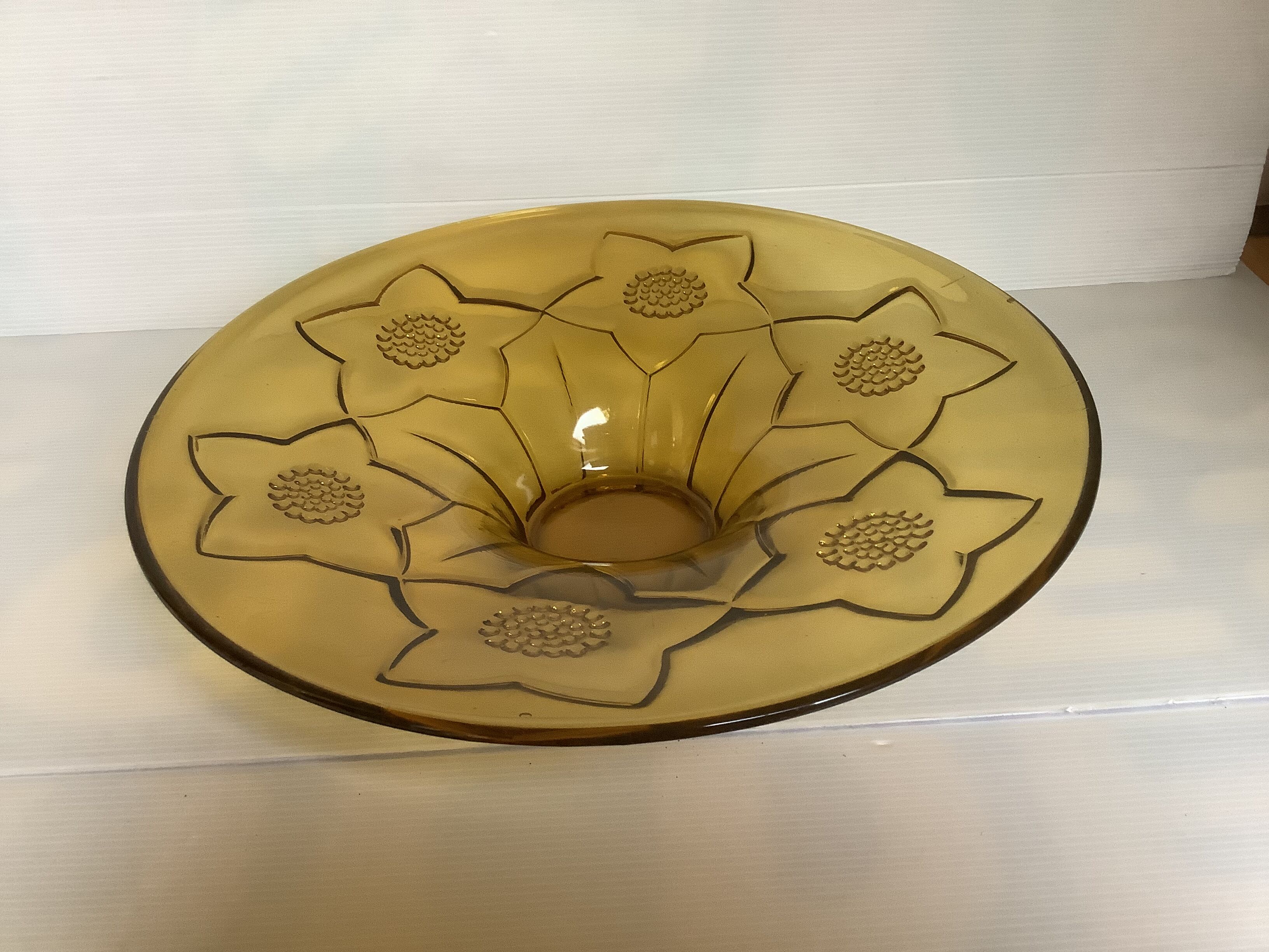 Yellow glass cup with a floral pattern