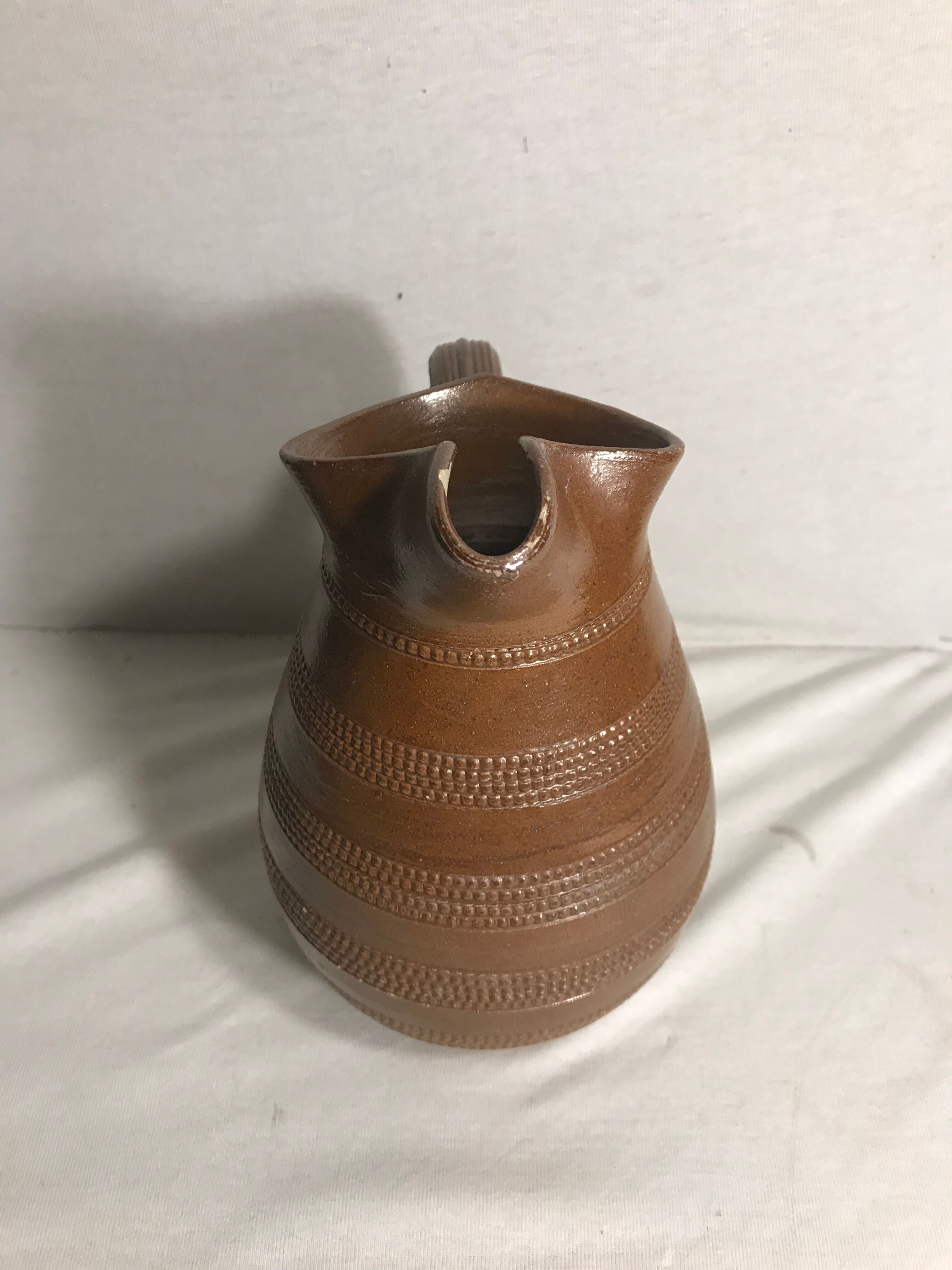 Old brown glazed ceramic jug from the 1950s