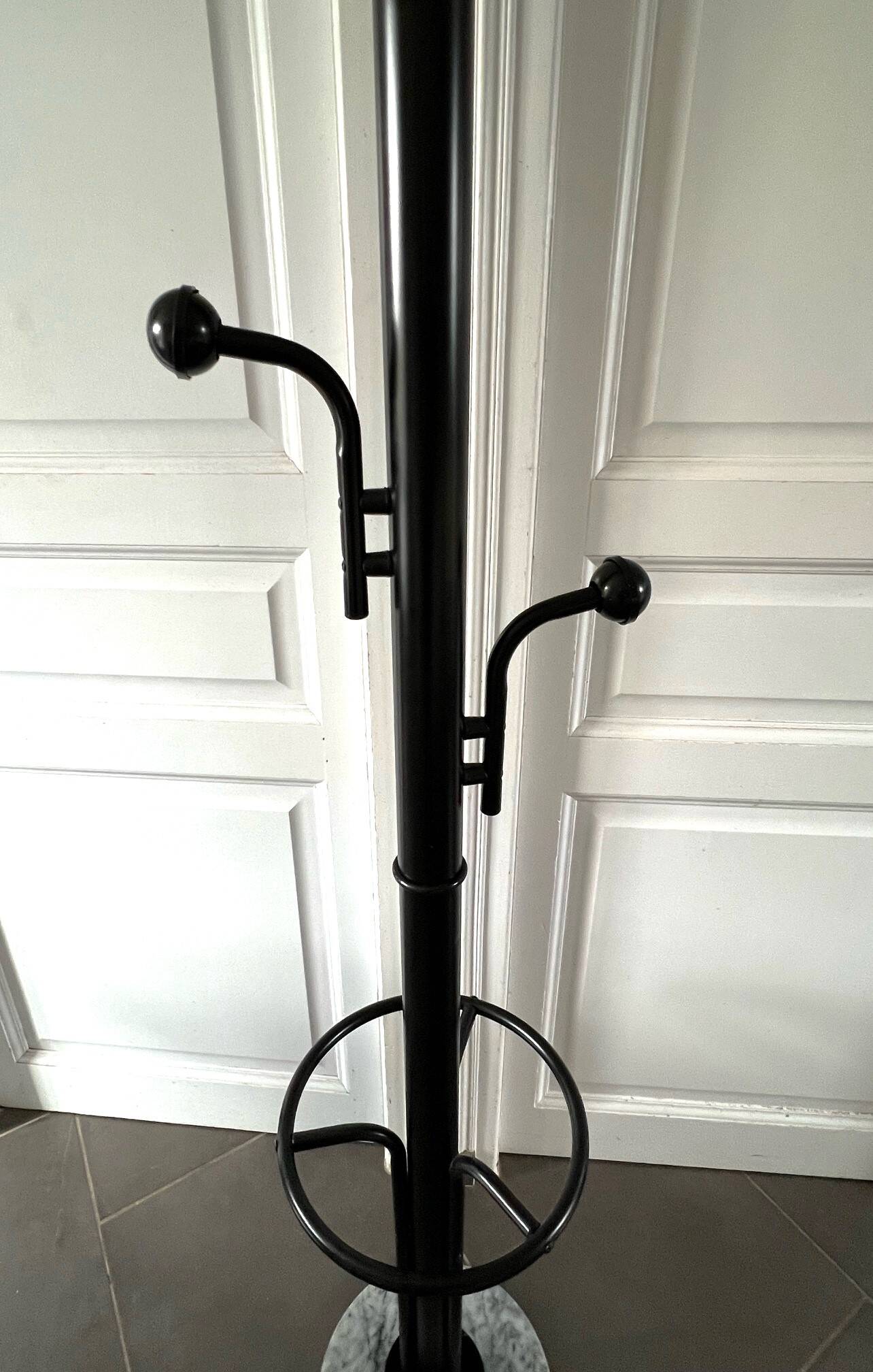 Black metal parrot coat rack on marble base