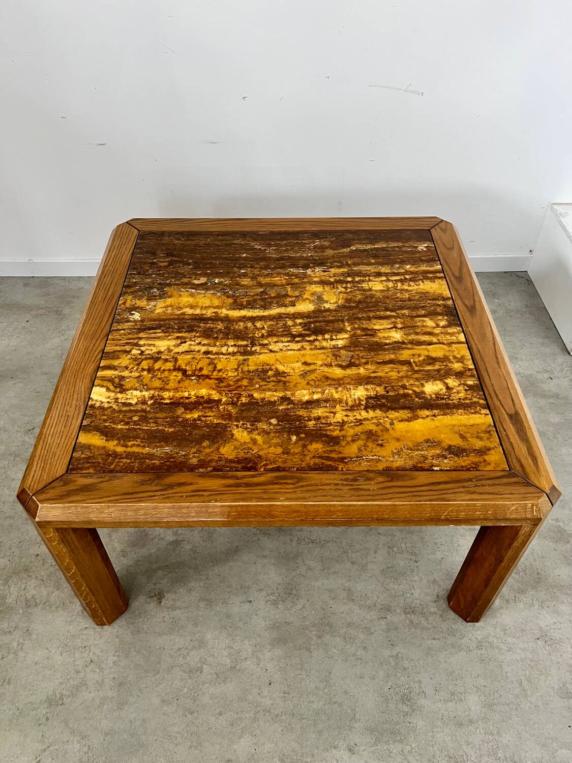 Old coffee table with golden marble top, 70s design, vintage wooden feet