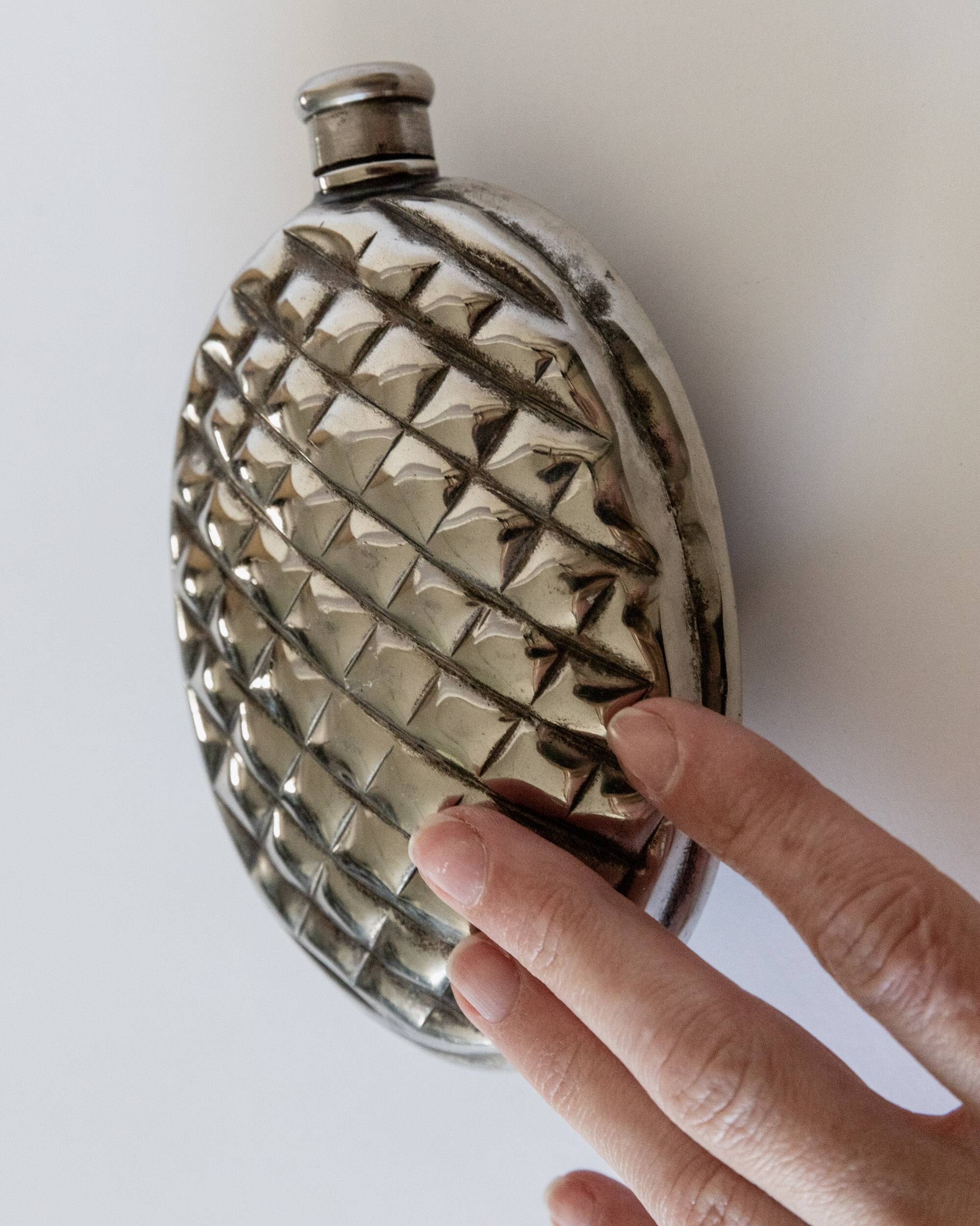 Vintage 1950s silver-plated flask in the shape of a pine cone.