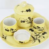 A yellow Art Deco ceramic tobacco service decorated with thistles from the 1920s to 1930s.