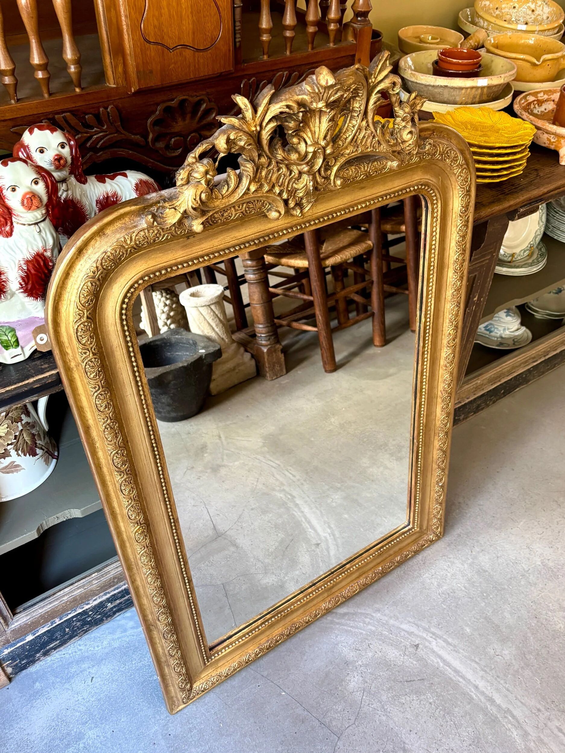 Gold sculpted and moulded stucco trumeau mirror 113 x 78 cm