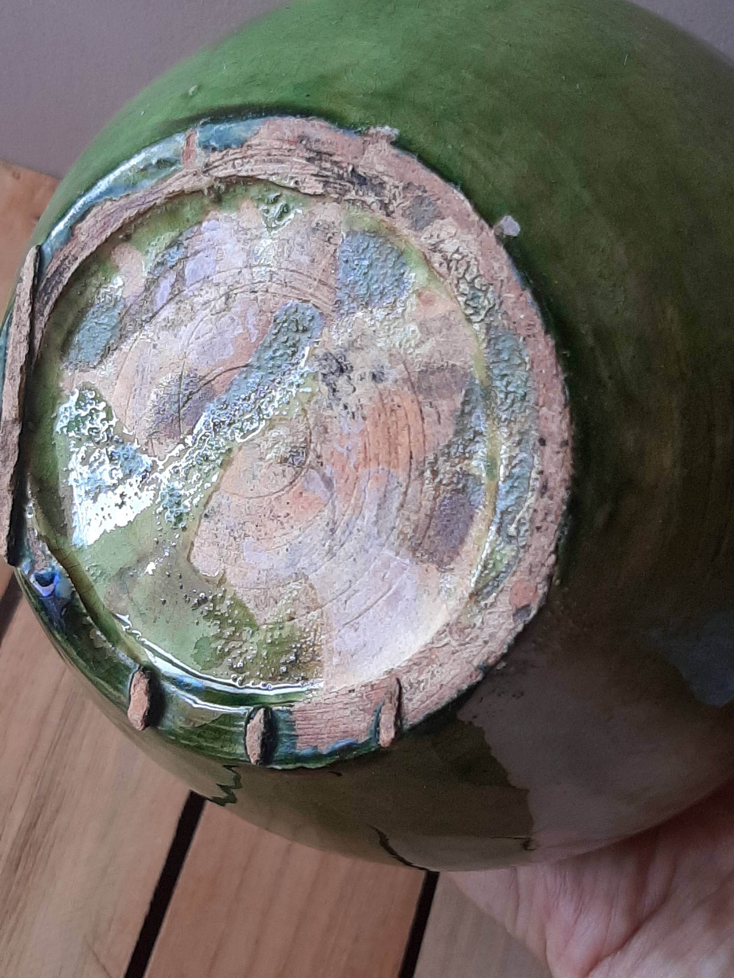 Ancient vase in glazed terracotta with green glaze.