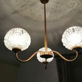 antique chandelier has 3 globes