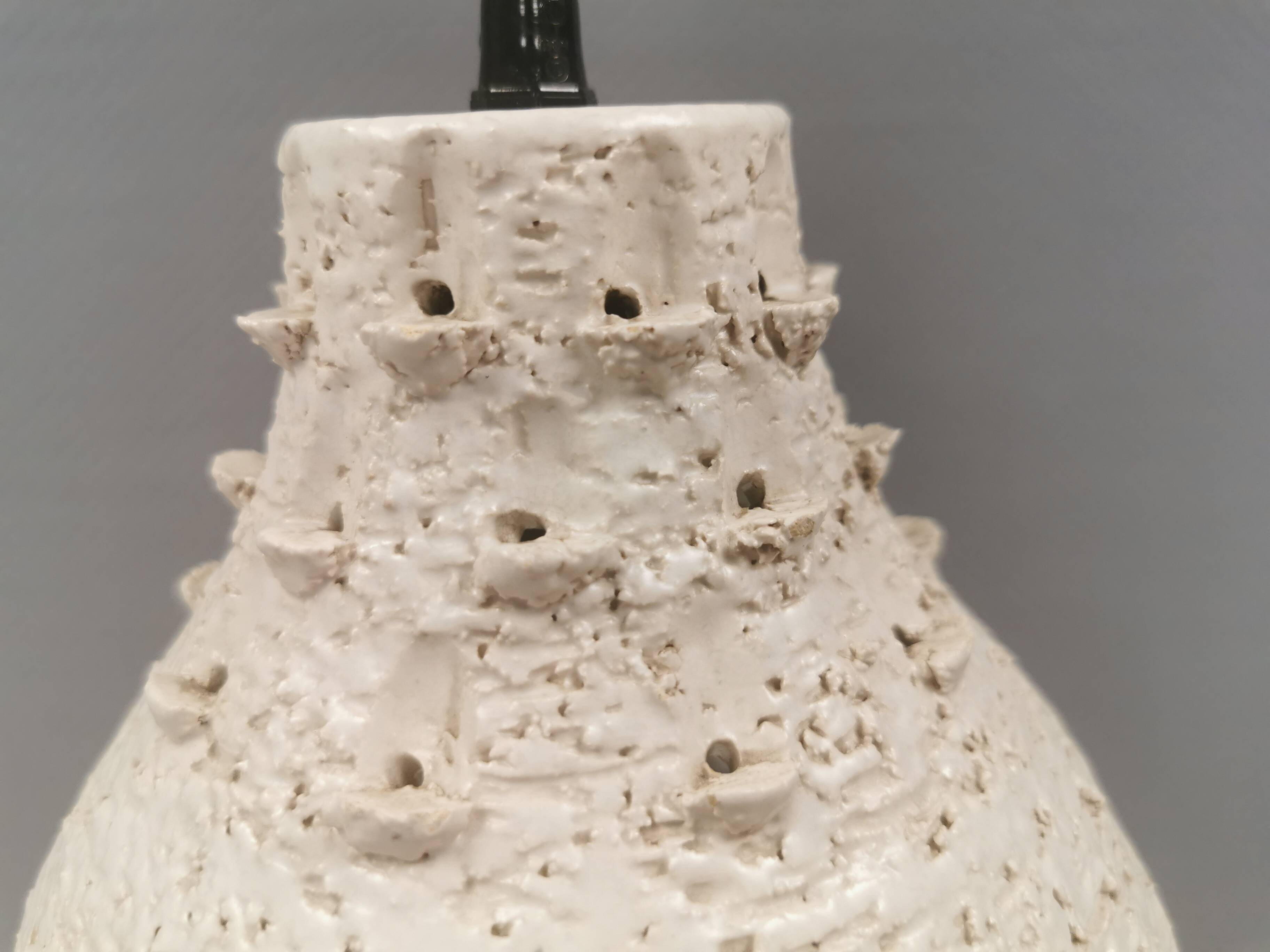 Ceramic hanging lamp in creamy white color that almost looks like a corral