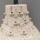 Ceramic hanging lamp in creamy white color that almost looks like a corral