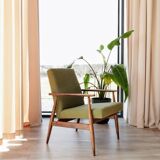 Mid-century modern armchair in olive green bouclé design by H. Lis.