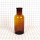 Rummaging in brown glass bottle