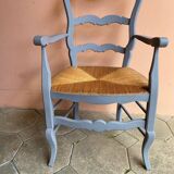 Provencal style straw armchair with gray blue patina armrests