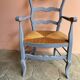 Provencal style straw armchair with gray blue patina armrests