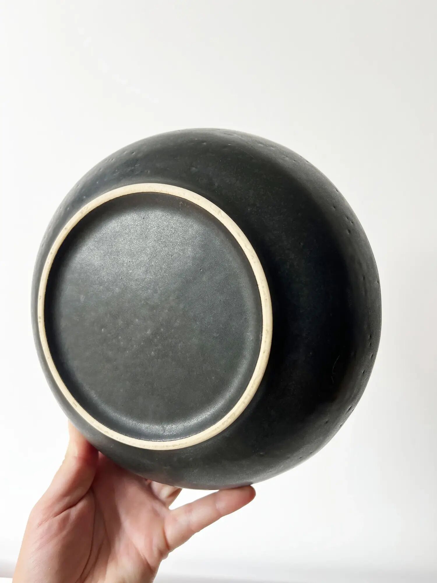 Round vintage black ceramic catchall.
