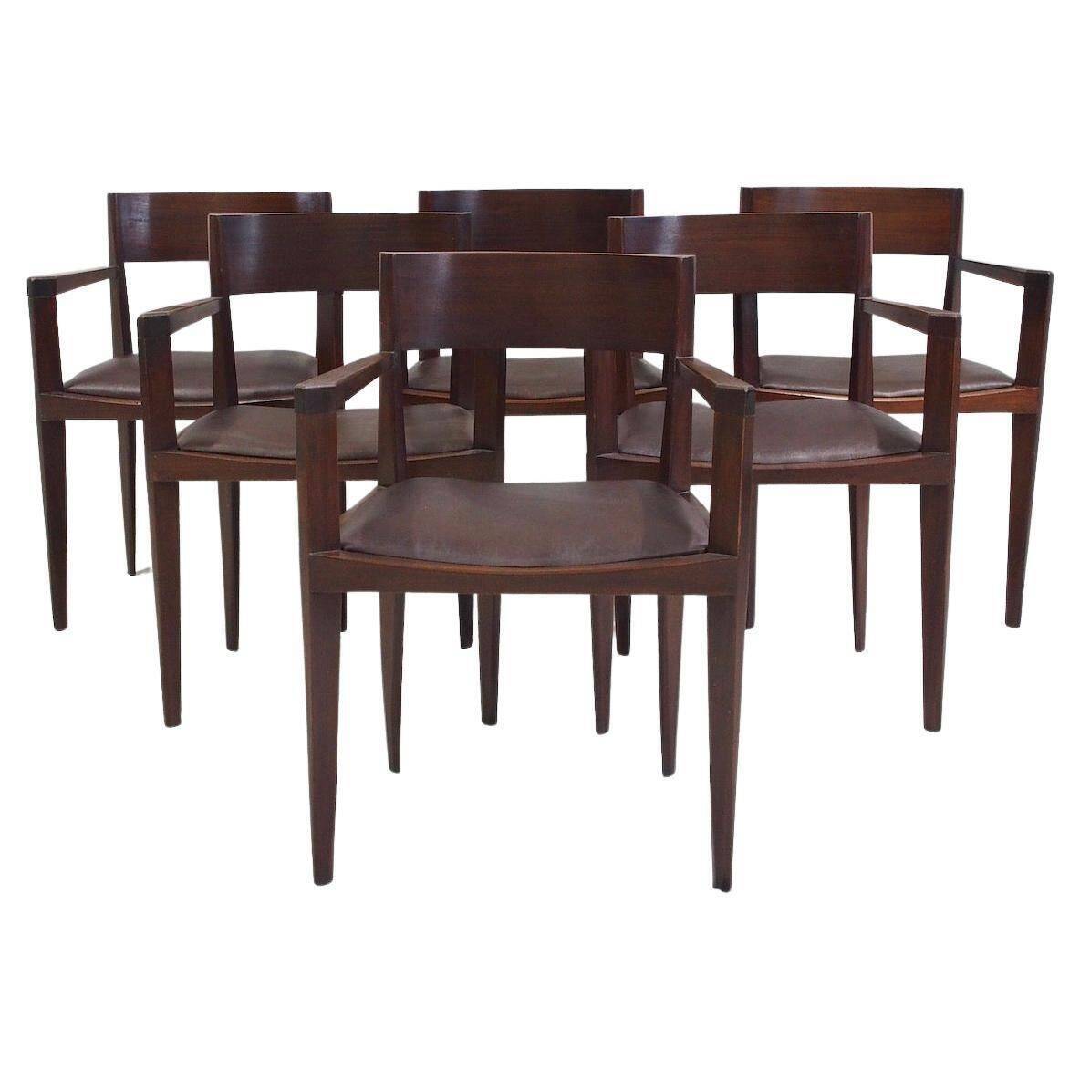 Set of six Italian wooden dining chairs in dark brown faux leather.