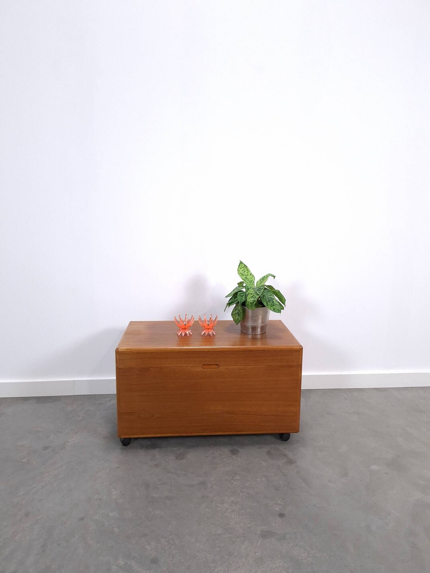 Vintage teak Danish chest with a lid on wheels, toy chest.