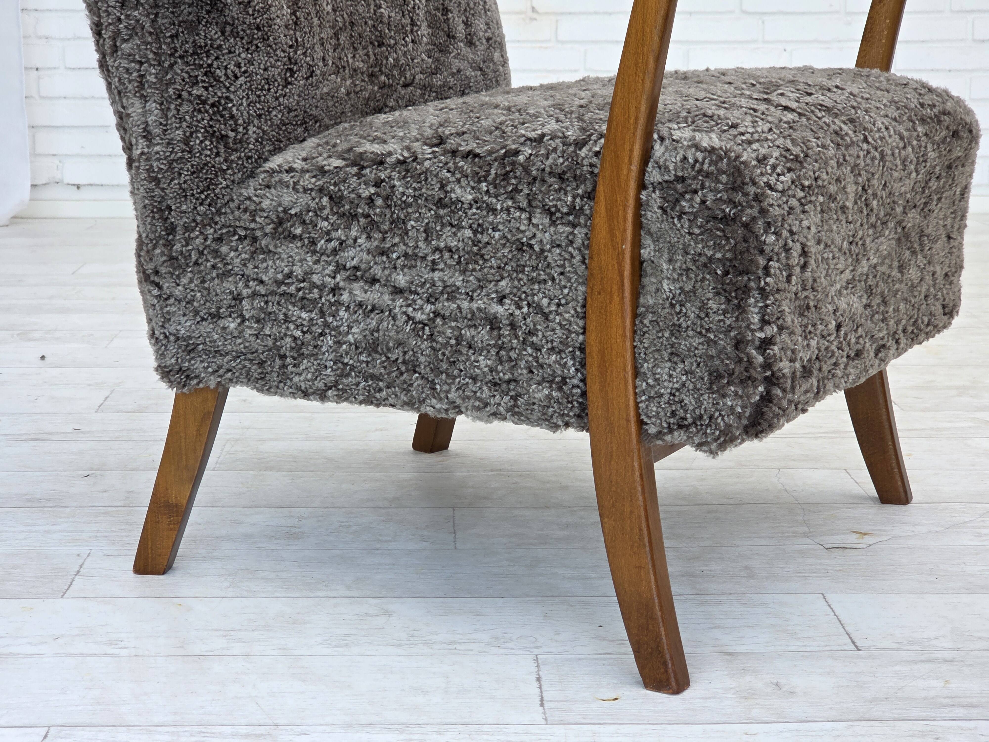 1960s, reupholstered Danish armchair, with stool, genuine sheepskin.
