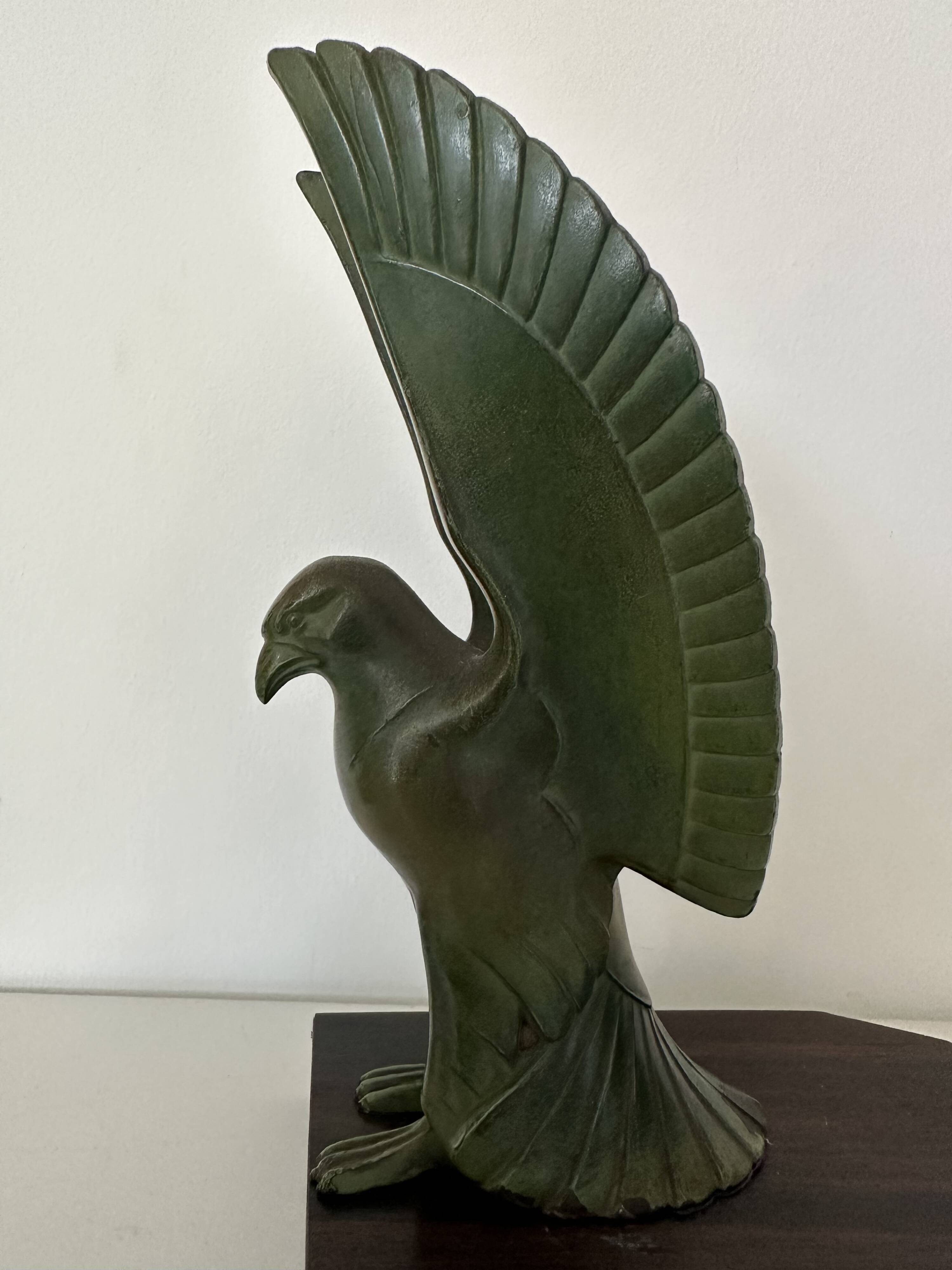 Pair of eagle bookends in green patina regula with rosewood base