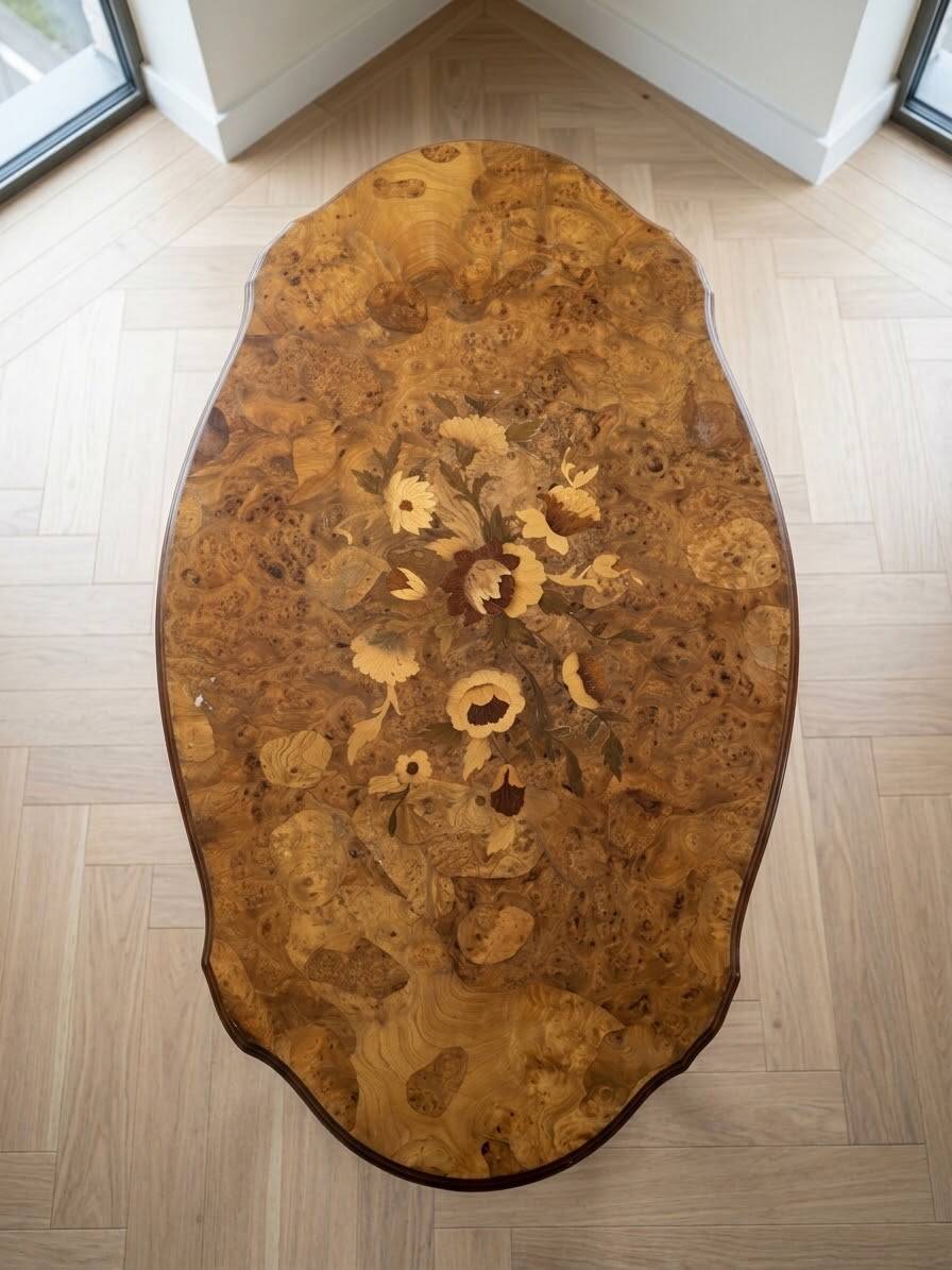 Oval coffee table in walnut burl wood.