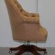 Chesterfield armchair in hardwood, leather, and woven linen.