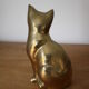Cat sitting in brass