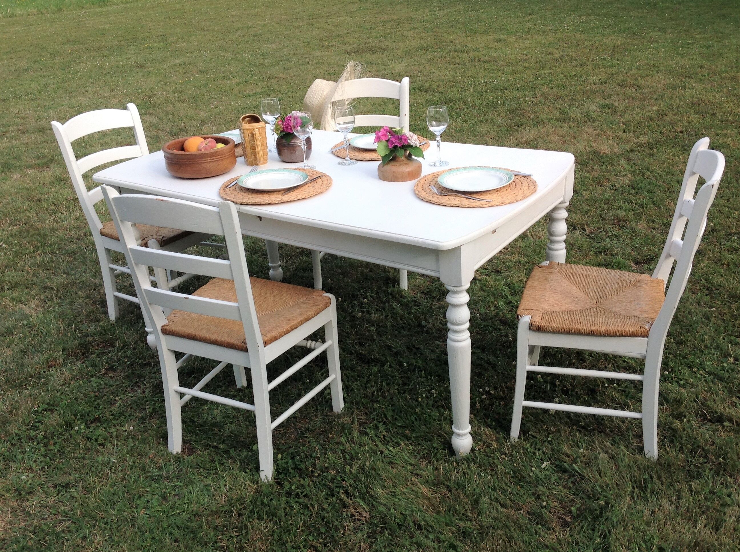 White farmhouse table set and four chairs