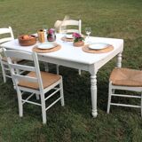 White farmhouse table set and four chairs