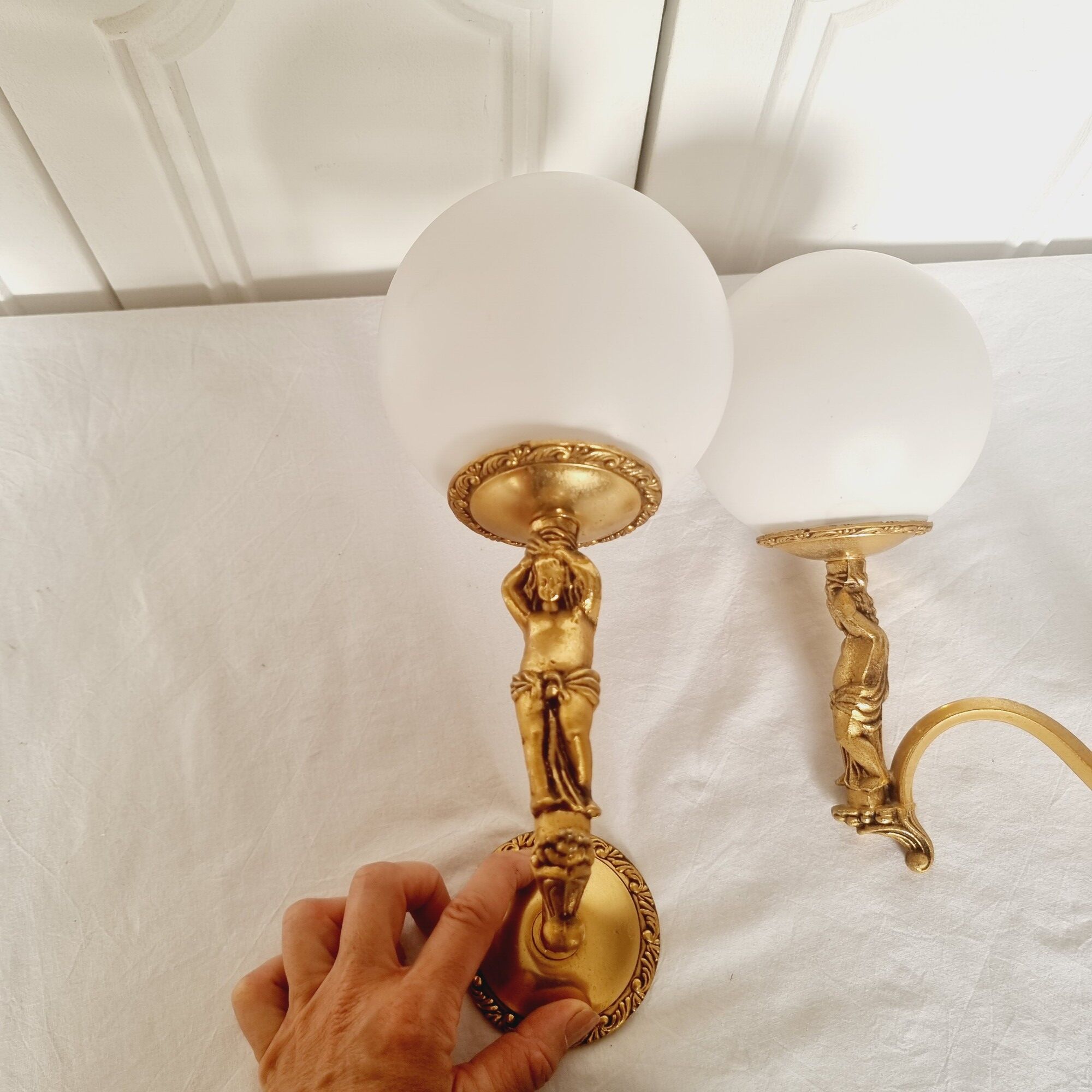 2 classic golden cherub wall lights and globe lampshades in perfect condition.