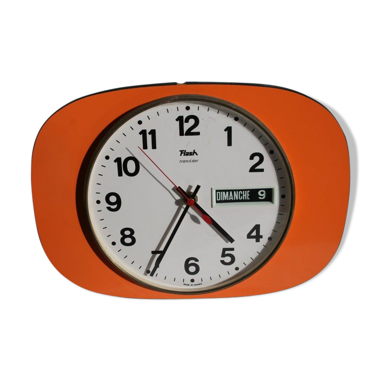 Vintage wall clock in orange formica