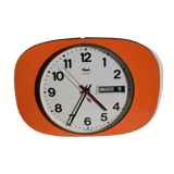 Vintage wall clock in orange formica